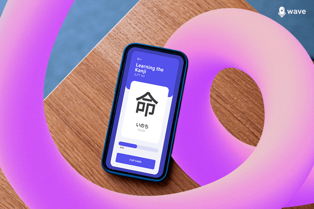 A phone is placed on a wooden surface, and flashcards are being created through an application